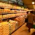 Customers countercheck the prices of maize flour at a supermarket in Nakuru City