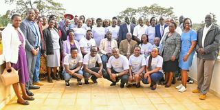 Governor Stephen Sang (in white coat at the centre) with some students and parents at Eliud Kipchoge Stadium in Kapsabet