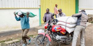 Farmers transport bags of subsidised fertiliser
