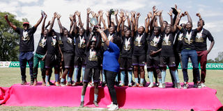 Soccer Assassins players celebrate with the trophy