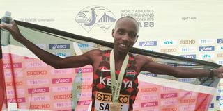 Kenya's Sebastian Sawe celebrates with the flag