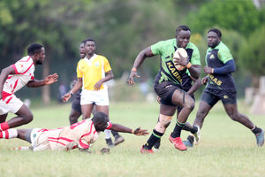 Kabras Sugar's George Nyambua (right) goes past Nondescript's Ian Omoke (down) 