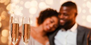 A couple celebrating Valentine's Day at a restaurant.