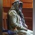 Stephen Njoroge Mbugua conceals his identity at the Milimani Law Courts on March 22, 2024