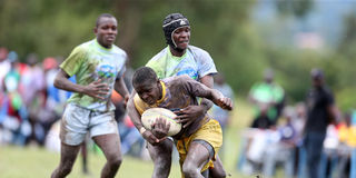 Butula Boys High School's Robert Carlos vies with Kisii High School's Matrix Matangi