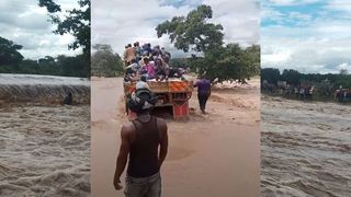 An attempt by some locals to cross the flooded river in a lorry ended in disaster when the vehicle was swept away.