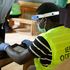 An Independent Election and Boundaries Commission (IEBC) official adorning a face shield and hand gloves uses the Kems kit