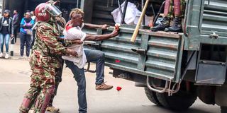 Police Officers arrest a protester during Nane Nane protests along Kimathi Street in Nairobi on August 8, 2024.