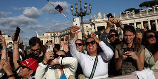 Faithful react to the white smoke indicating that a new pope has been elected